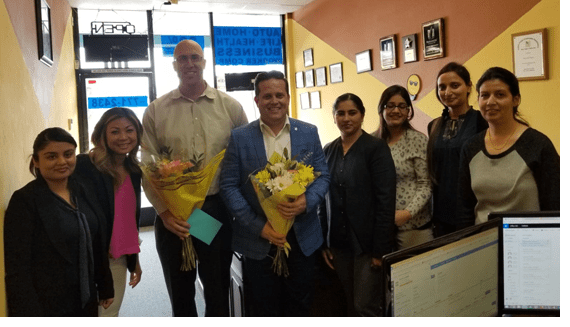 Team celebrating success with flowers.
