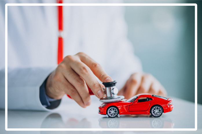 Doctor using stethoscope on red toy car