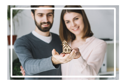 Couple holding miniature wooden house model